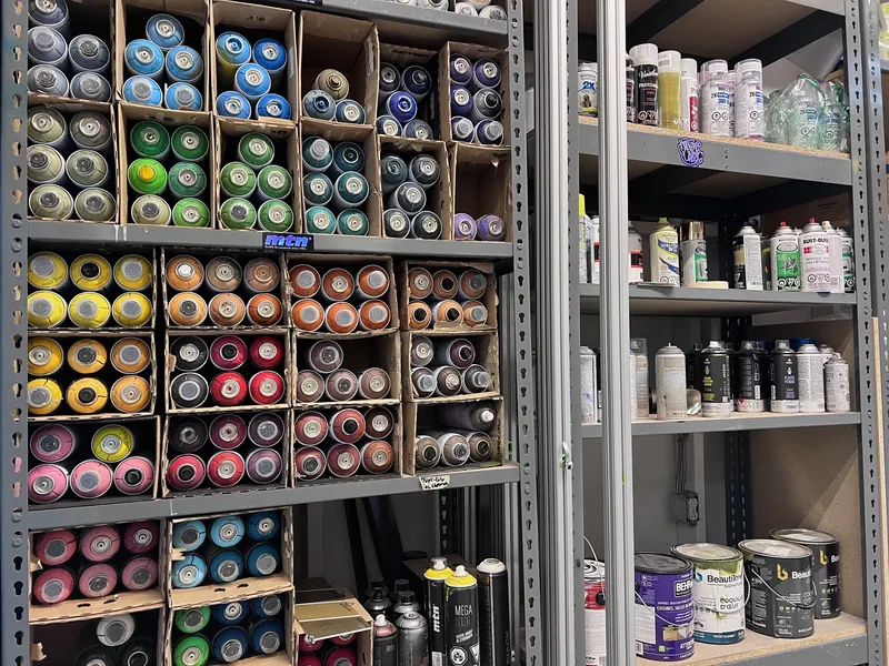 Shelves of spray paints in the workshop